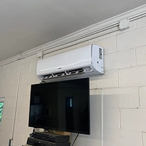 Wall-Mounted Air Conditioner Above Television in Modesto, CA Commercial Space