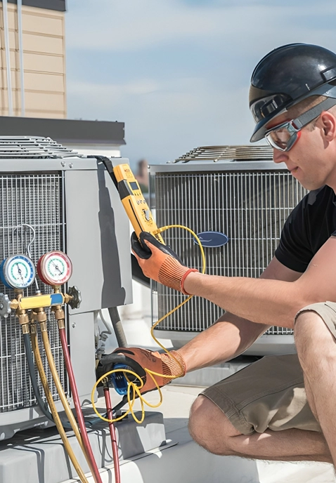 Technician Performing Commercial Refrigeration Repair in Modesto, CA on a Rooftop Unit