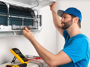 Technician Inspecting Air Conditioning Unit for Commercial Refrigeration Repair